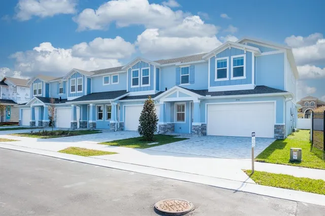 a front view of a house with a yard outdoor seating and garage