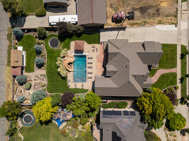 687 South 2080th Street East Springville, UT 84663 - Photo 72 of 149 Extensive backyard featuring a swimming pool with attached water slide, a pergola-covered patio, mature landscaping, a trampoline, and a lawn area