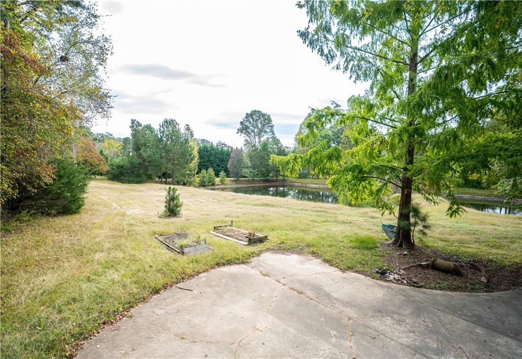 611 Couch Road Dawsonville, GA 30534 - Photo 26 of 26 a view of yard with swimming pool and trees in the background