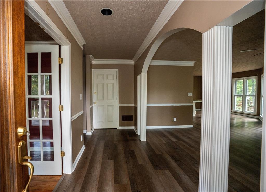 611 Couch Road Dawsonville, GA 30534 - Photo 5 of 26 a view of a hallway with wooden floor and staircase