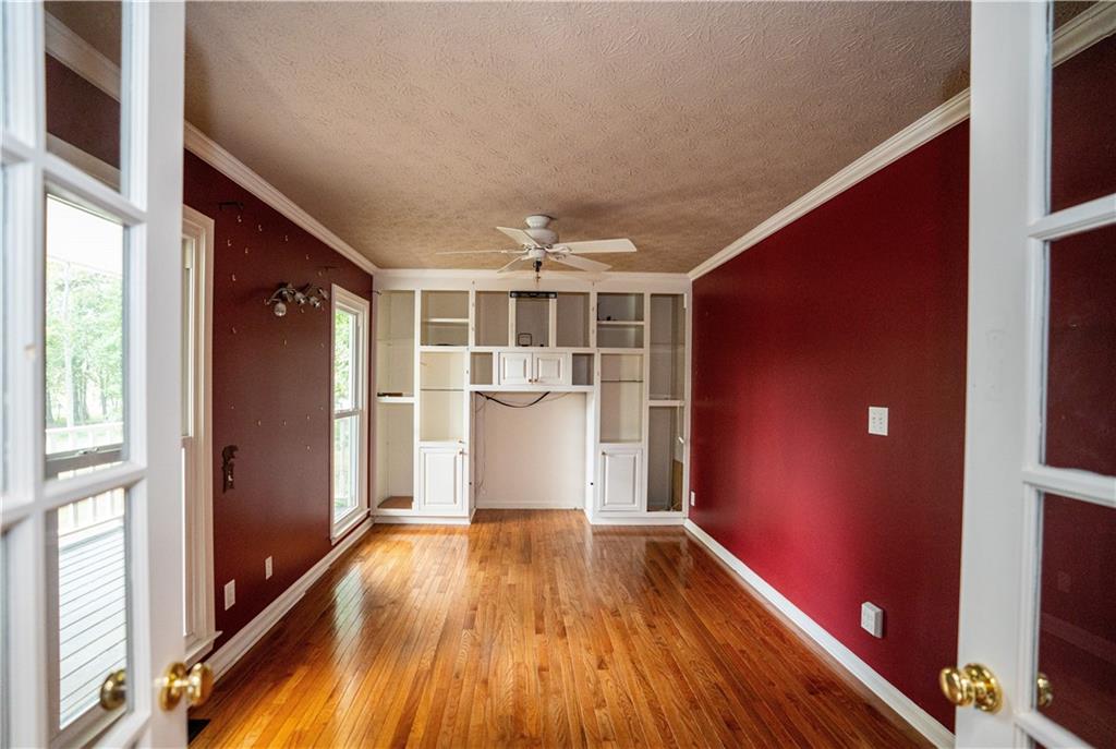 611 Couch Road Dawsonville, GA 30534 - Photo 6 of 26 a view of a big room with wooden floor and windows