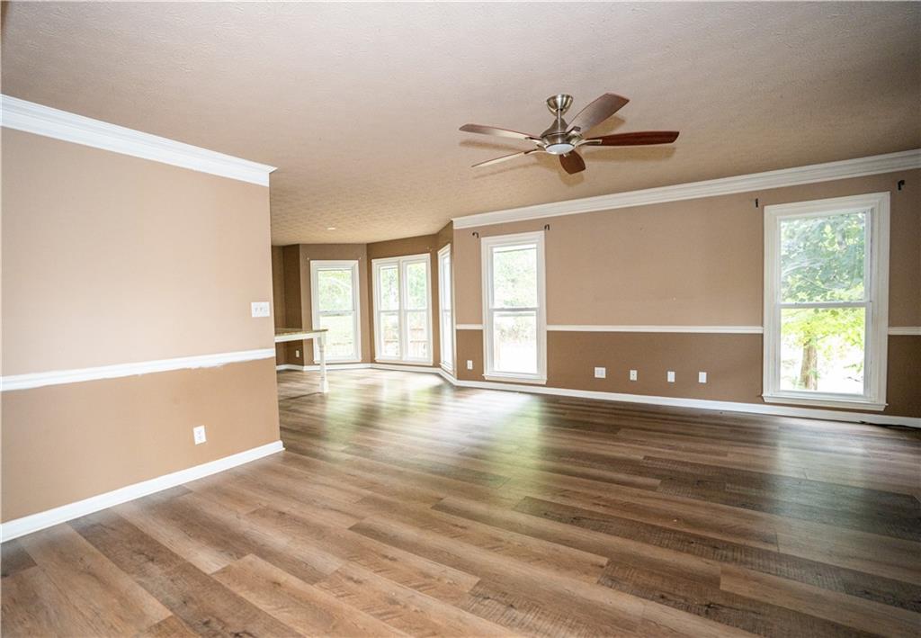 611 Couch Road Dawsonville, GA 30534 - Photo 8 of 26 a view of an empty room with window and wooden floor
