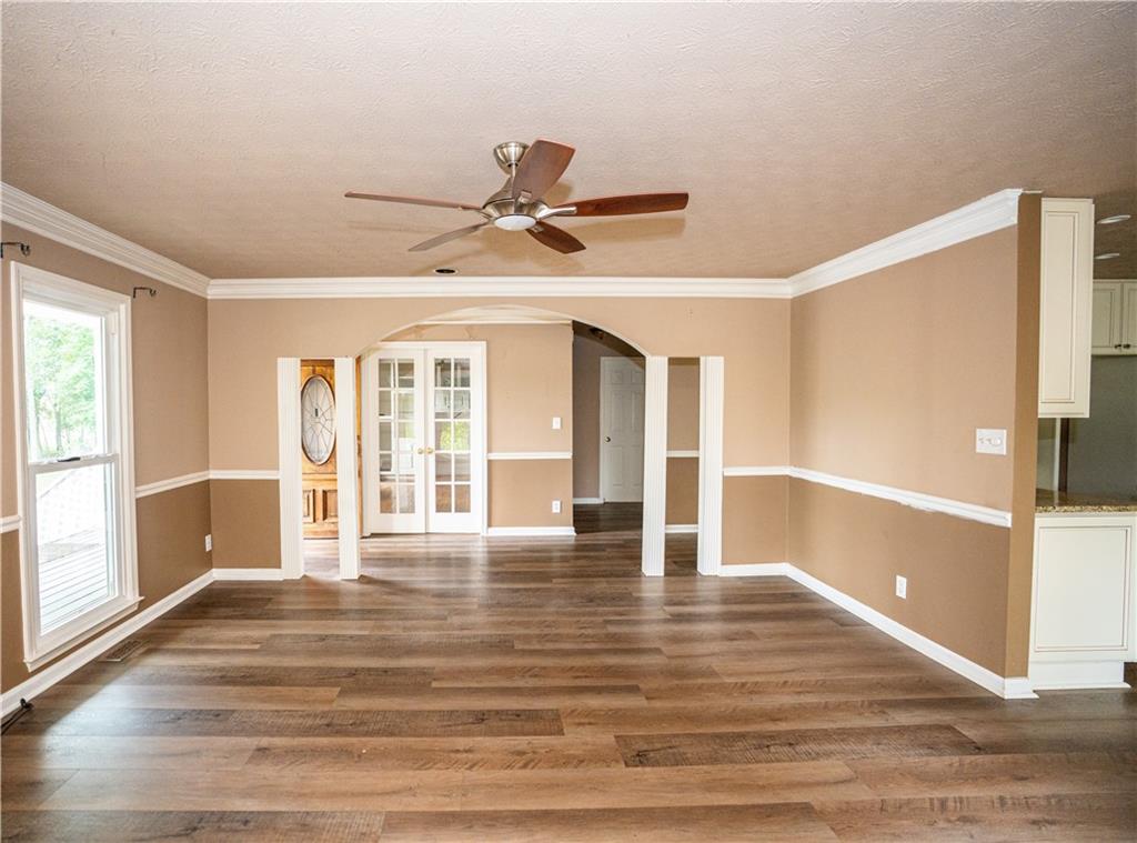 611 Couch Road Dawsonville, GA 30534 - Photo 9 of 26 a view of an empty room with wooden floor and a window