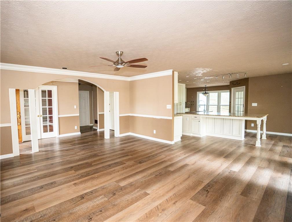 611 Couch Road Dawsonville, GA 30534 - Photo 10 of 26 a view of an empty room with wooden floor and a window