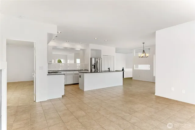 a view of kitchen with kitchen island a counter top space appliances and cabinets