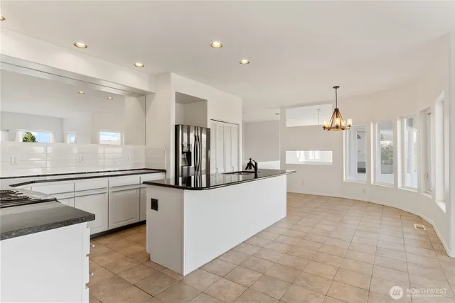 a view of a kitchen with a sink and cabinets