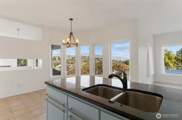 a kitchen with a sink a counter space and windows