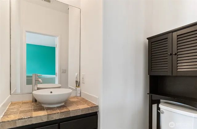 a view of a bathroom with a potted plant and a sink