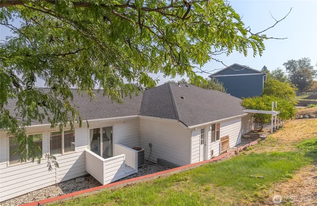 a aerial view of a house with a yard and sitting area