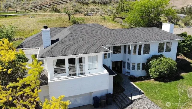 aerial view of a house with a yard and potted plants