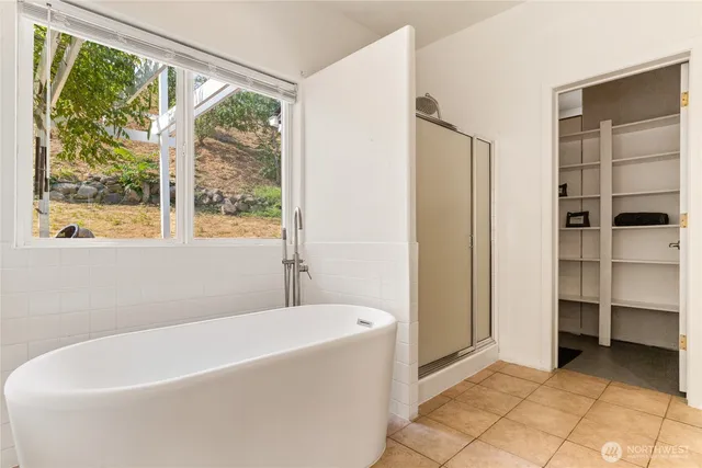 a white bath tub sitting next to a window