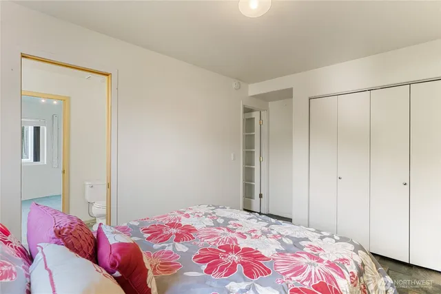 a bedroom with a bed and a closet