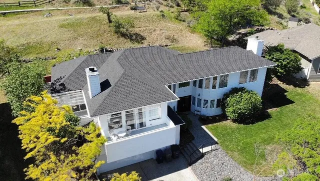 an aerial view of a house with a yard