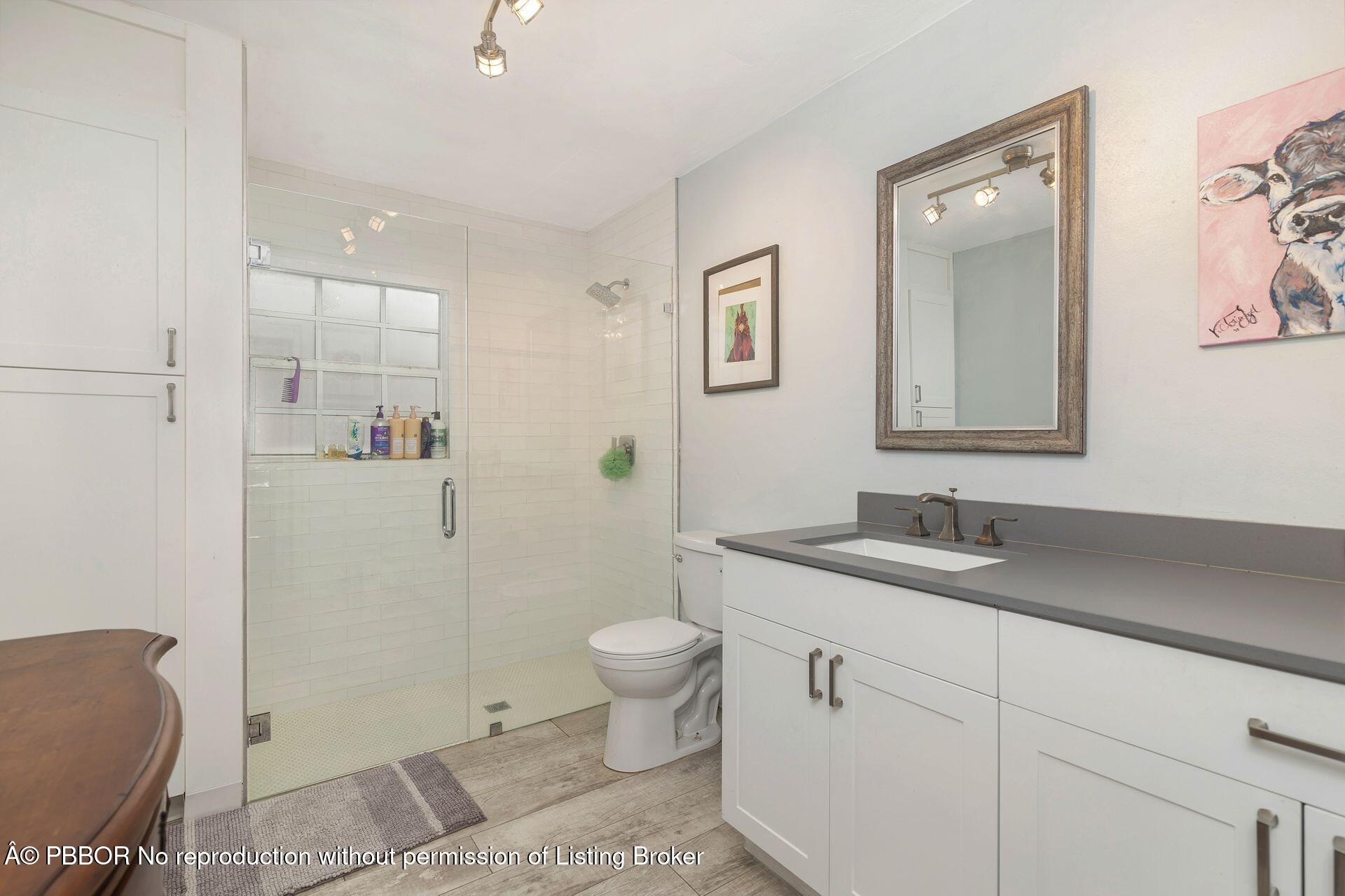 2770 E Road Loxahatchee, FL 33470 - Photo 16 of 51 a bathroom with a sink toilet and vanity