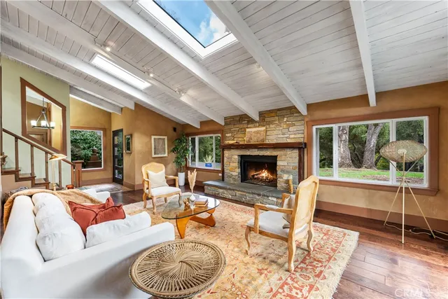 a living room with furniture a fireplace and a table