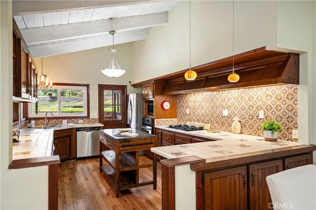 a kitchen with a stove and a refrigerator
