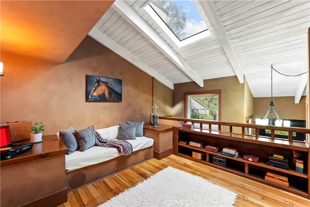 a living room with furniture a rug and a window