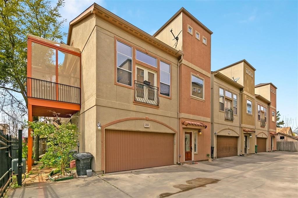 a view of a house with a garage and balcony