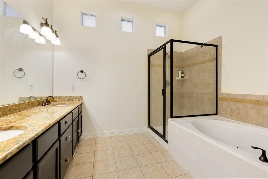 4316 Eli Street Houston, TX 77007 - Photo 11 of 20 a bathroom with a granite countertop sink a mirror and shower