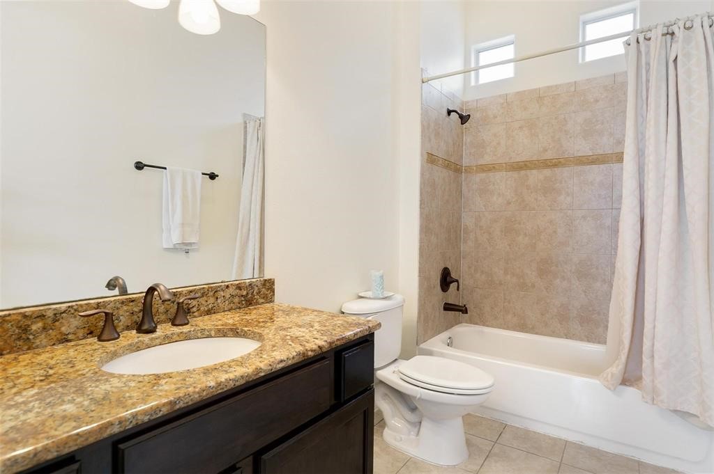 4316 Eli Street Houston, TX 77007 - Photo 14 of 20 a bathroom with a granite countertop sink toilet and shower