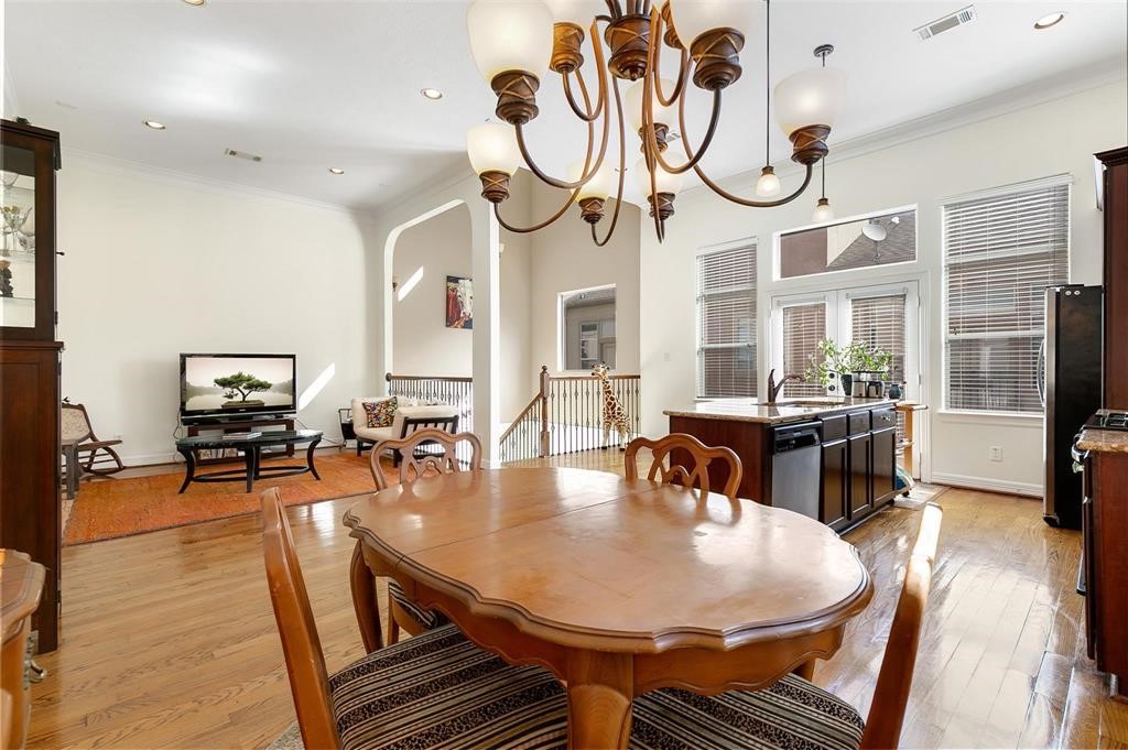 4316 Eli Street Houston, TX 77007 - Photo 3 of 20 a dining room with wooden floor a chandelier a wooden table and chairs