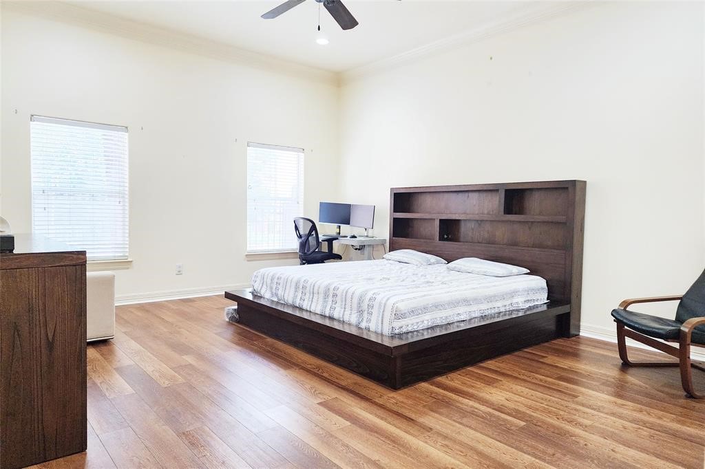 4316 Eli Street Houston, TX 77007 - Photo 9 of 20 a bedroom with a bed and wooden floor