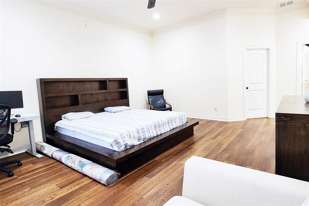 4316 Eli Street Houston, TX 77007 - Photo 10 of 20 a bedroom with a bed and wooden floor