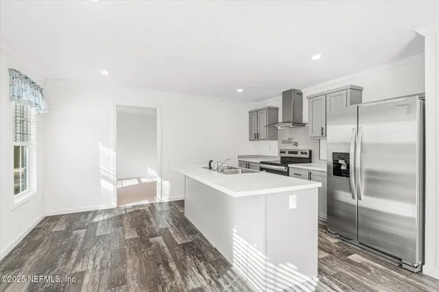 a kitchen with a sink stainless steel appliances and white cabinets