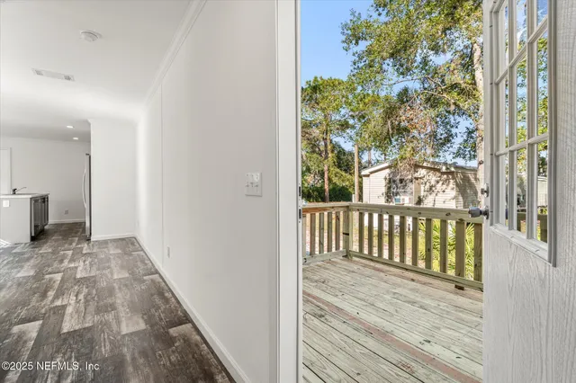 a balcony with wooden floor and fence