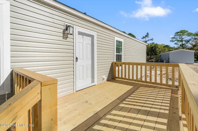 an aerial view of house with sign board and yard