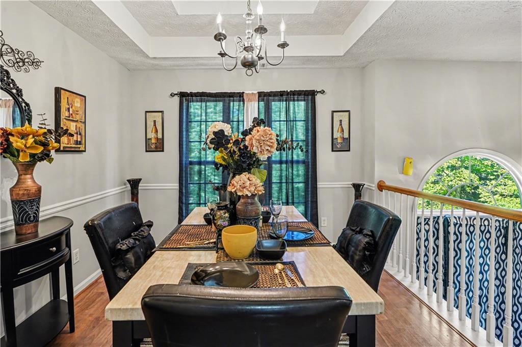 176 Shoreline Way Hampton, GA 30228 - Photo 12 of 32 a view of a dining room with furniture a chandelier and wooden floor