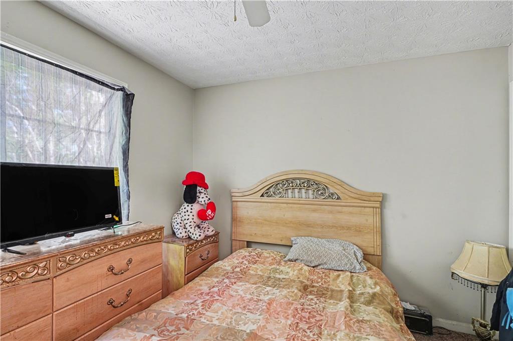 176 Shoreline Way Hampton, GA 30228 - Photo 14 of 32 a spacious bedroom with a bed and flat screen tv