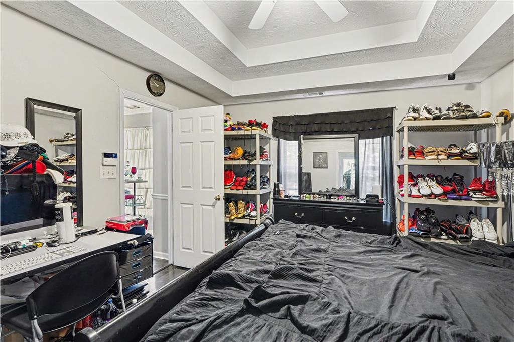 176 Shoreline Way Hampton, GA 30228 - Photo 17 of 32 a bed room with a bed and a tv