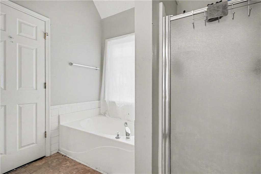 176 Shoreline Way Hampton, GA 30228 - Photo 18 of 32 a white bath tub sitting next to a shower