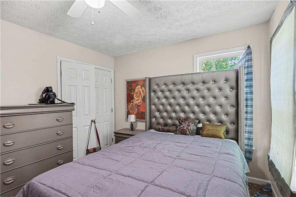 176 Shoreline Way Hampton, GA 30228 - Photo 20 of 32 a bedroom with a bed and a window