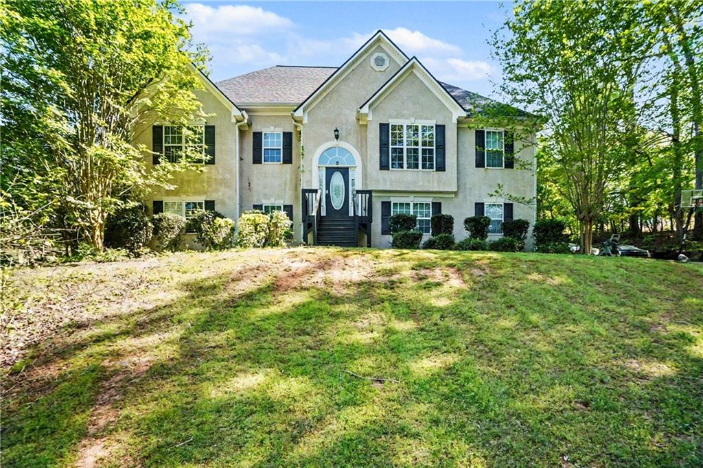 176 Shoreline Way Hampton, GA 30228 - Photo 2 of 32 a front view of a house with a yard