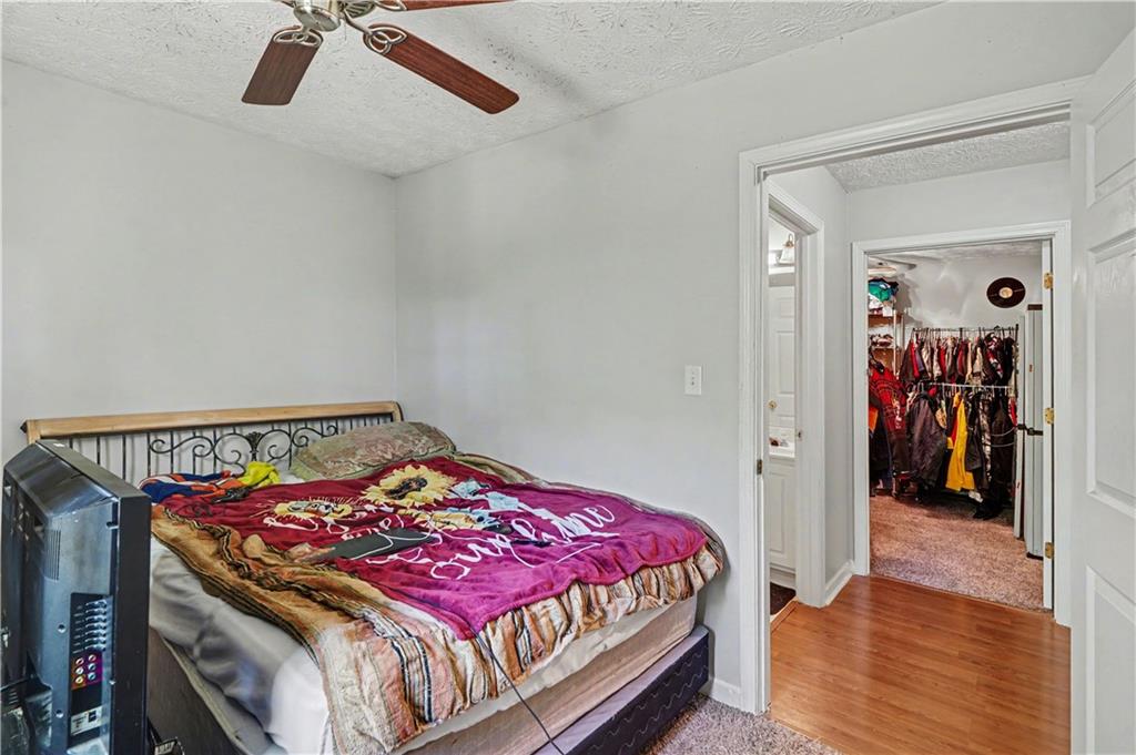 176 Shoreline Way Hampton, GA 30228 - Photo 27 of 32 a bedroom with a bed and a walk in closet