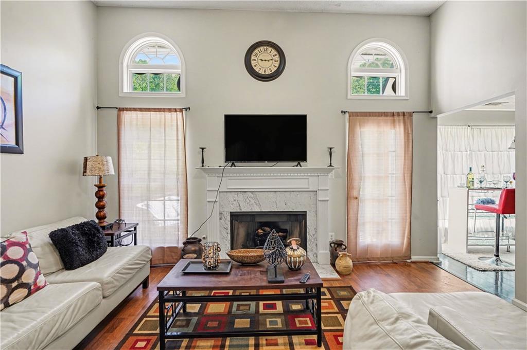 176 Shoreline Way Hampton, GA 30228 - Photo 5 of 32 a living room with furniture a fireplace and a flat screen tv