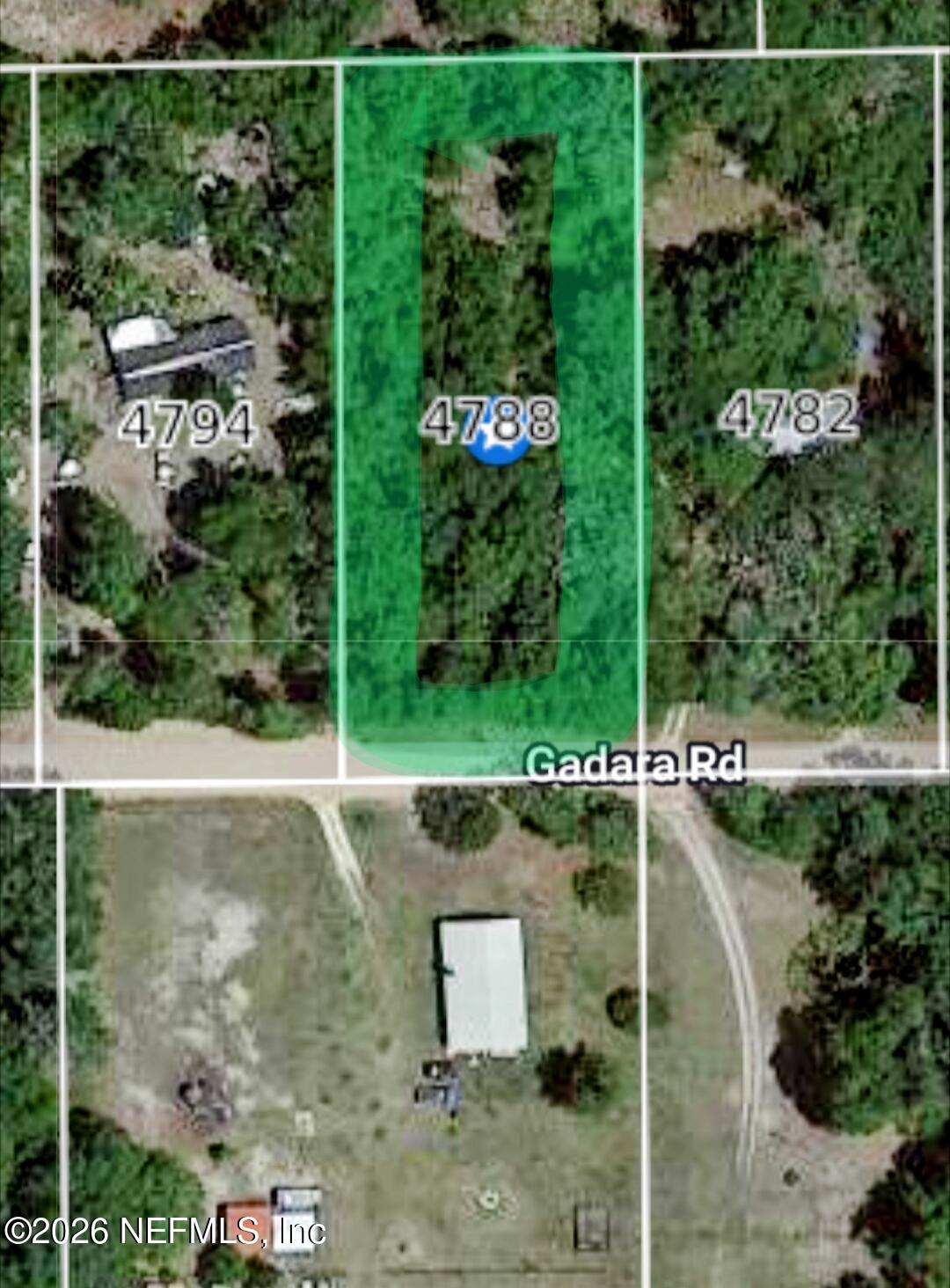 an aerial view of a residential houses with outdoor space