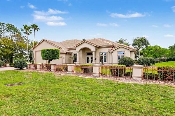 a front view of a house with a garden and yard