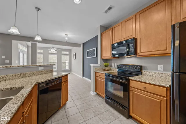 a kitchen with granite countertop a sink and a wooden floor