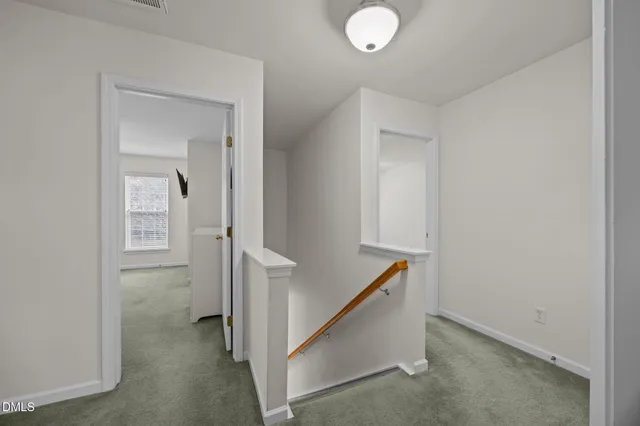 a bedroom with a bed dresser and a window