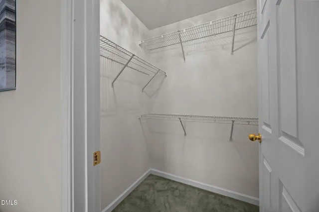 a bedroom with a bed chandelier and a window