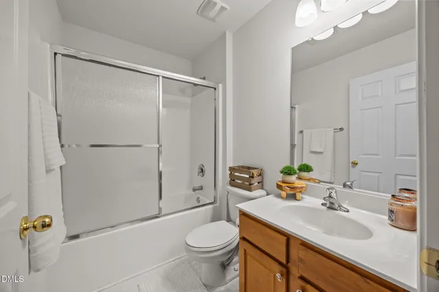 an empty room with a chandelier fan and windows