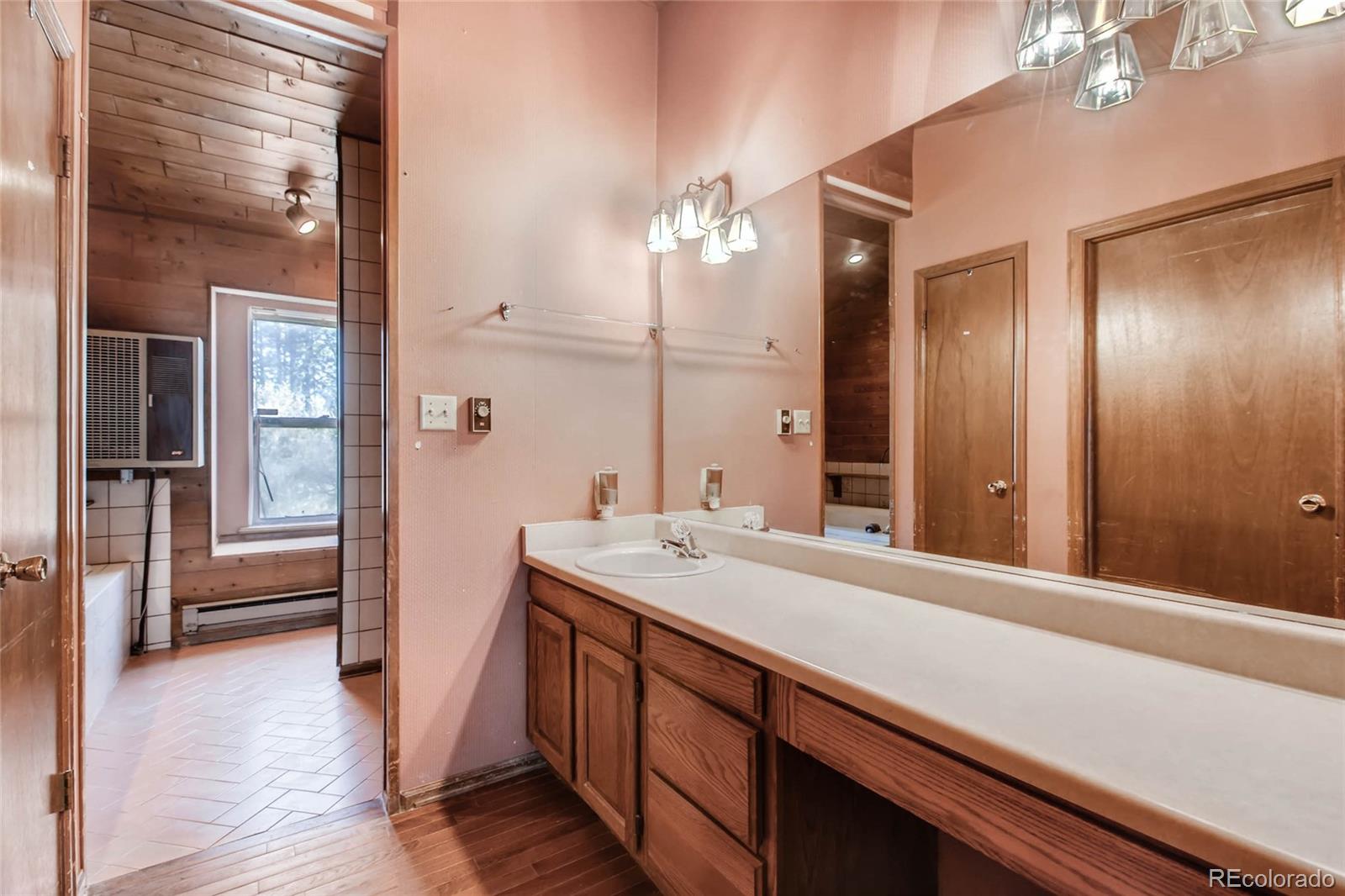 18755 Ranch Hand Road Peyton, CO 80831 - Photo 15 of 27 a bathroom with a sink and a mirror