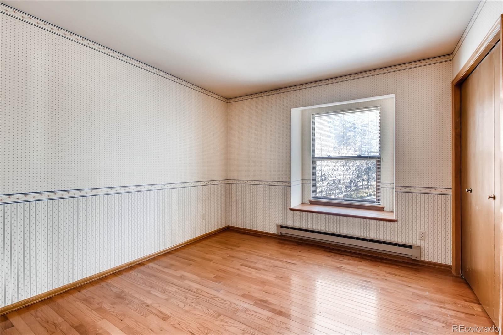 18755 Ranch Hand Road Peyton, CO 80831 - Photo 17 of 27 a view of an empty room with wooden floor and a window