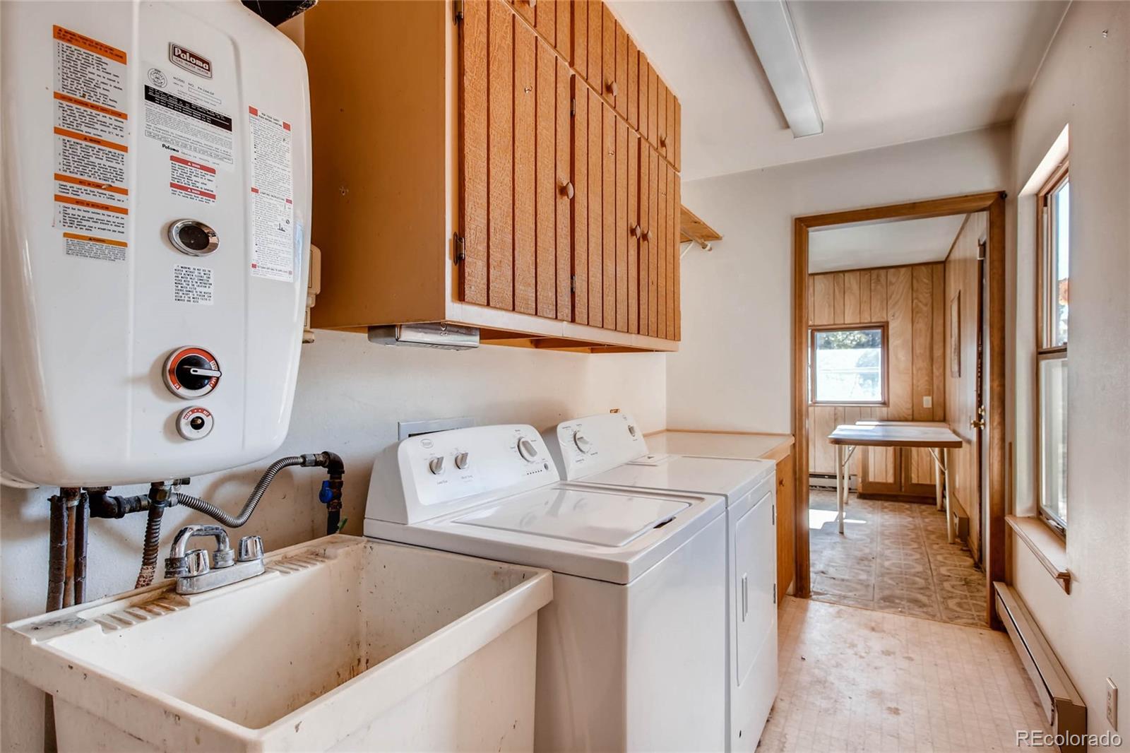 18755 Ranch Hand Road Peyton, CO 80831 - Photo 19 of 27 a kitchen with a sink a stove and a refrigerator