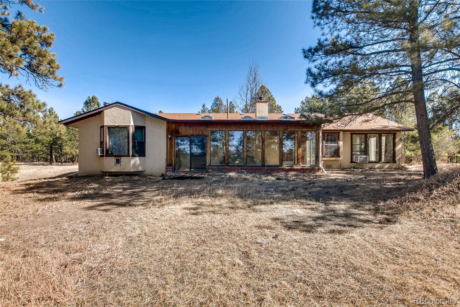 18755 Ranch Hand Road Peyton, CO 80831 - Photo 25 of 27 a front view of a house with a yard