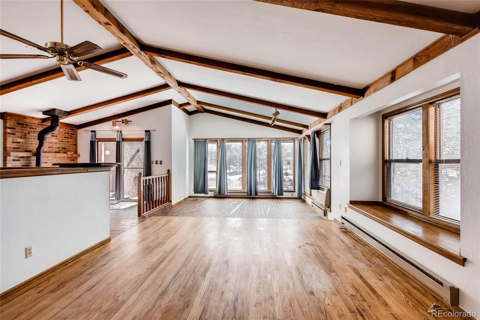 18755 Ranch Hand Road Peyton, CO 80831 - Photo 6 of 27 a view of an empty room with wooden floor and a window