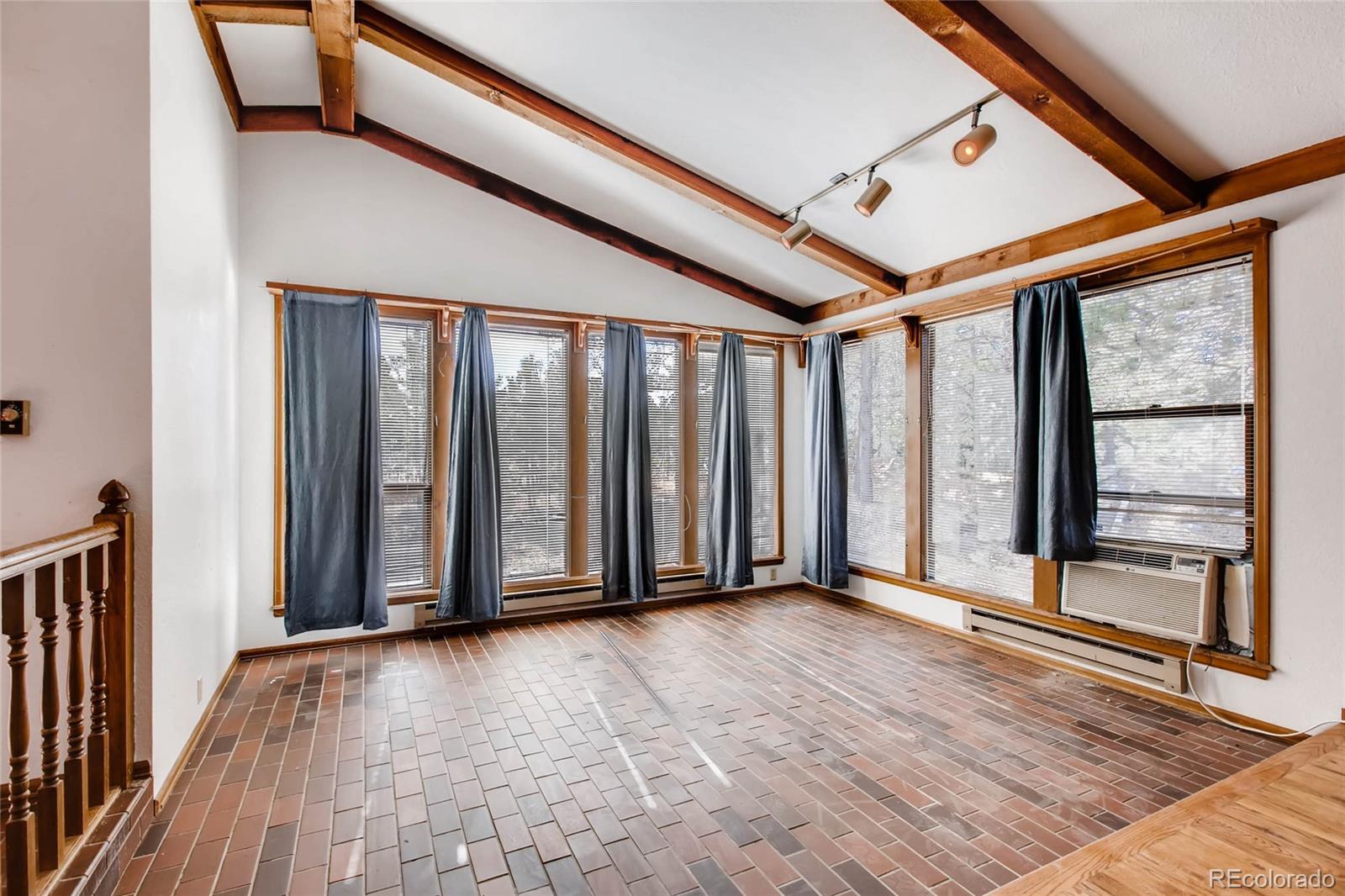 18755 Ranch Hand Road Peyton, CO 80831 - Photo 7 of 27 an empty room with wooden floor and windows